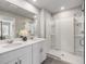 Modern bathroom with double vanity, quartz countertop, glass shower, and neutral color palette for a clean, contemporary space at 2710 Chestnut Creek Pl, Brandon, FL 33510