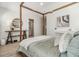 This bedroom features a four poster bed, with a modern decor and ensuite bathroom, perfect for a tranquil retreat at 2710 Chestnut Creek Pl, Brandon, FL 33510
