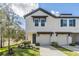 Charming townhome with a well-manicured lawn, inviting entrance, and attached garages under a sunny sky at 2710 Chestnut Creek Pl, Brandon, FL 33510