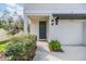 Inviting front entrance of home with a well-kept lawn and a freshly painted front door at 2710 Chestnut Creek Pl, Brandon, FL 33510
