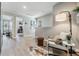 Bright hallway with wood floors, modern decor, and an open doorway to another room, creating a welcoming and stylish transition at 2710 Chestnut Creek Pl, Brandon, FL 33510