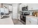 Modern kitchen with stainless steel appliances, white cabinets, and sleek countertops at 2710 Chestnut Creek Pl, Brandon, FL 33510