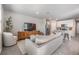 Spacious living area with tile flooring, a comfortable sofa, and modern decor leading into the kitchen at 2710 Chestnut Creek Pl, Brandon, FL 33510