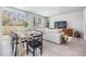 Open living and dining area featuring a large window, stylish decor, and comfortable seating at 2710 Chestnut Creek Pl, Brandon, FL 33510