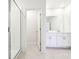 Bright bathroom featuring double vanity, a glass enclosed shower offering a luxurious and efficient space at 31640 Malbec Dr, Brooksville, FL 34602