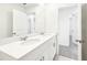 Modern bathroom with double sink vanity, white cabinets, quartz countertop, and large mirror at 31640 Malbec Dr, Brooksville, FL 34602