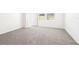 Cozy bedroom featuring a neutral carpet, natural light, and a spacious closet at 31640 Malbec Dr, Brooksville, FL 34602