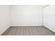 Bedroom with neutral carpet, bright white walls, and a sliding door closet for storage at 31640 Malbec Dr, Brooksville, FL 34602
