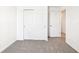 Bedroom featuring neutral carpet, and a double closet with sliding doors, providing ample storage at 31640 Malbec Dr, Brooksville, FL 34602