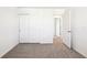 Neutral bedroom showcasing light gray carpet, a closet, and an open door at 31640 Malbec Dr, Brooksville, FL 34602