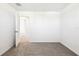 Neutral bedroom showcasing light gray carpet and an open door at 31640 Malbec Dr, Brooksville, FL 34602