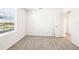 Bedroom featuring neutral carpet, bright window and view, with a door leading to more rooms at 31640 Malbec Dr, Brooksville, FL 34602