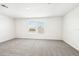 Spacious bedroom featuring neutral colored carpet and two bright, large windows at 31640 Malbec Dr, Brooksville, FL 34602