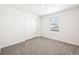 Bright bedroom features neutral carpet, closet, and a window that provides ample natural light at 31640 Malbec Dr, Brooksville, FL 34602