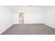 Bedroom with plush carpeting leading to a bathroom with a dual sink vanity at 31640 Malbec Dr, Brooksville, FL 34602