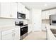 Modern kitchen featuring white cabinets, stainless steel appliances, and sleek countertops at 31640 Malbec Dr, Brooksville, FL 34602