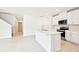 Bright eat-in kitchen featuring an island, stainless steel appliances, and white cabinetry at 31640 Malbec Dr, Brooksville, FL 34602