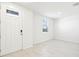 Bright and spacious living room with tiled flooring and a large window by the front door at 31640 Malbec Dr, Brooksville, FL 34602