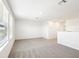 Carpeted loft area featuring a large window for natural light at 31640 Malbec Dr, Brooksville, FL 34602