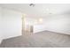 Carpeted loft area featuring an adjoining doorway and stairs at 31640 Malbec Dr, Brooksville, FL 34602