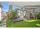 Backyard area featuring a deck with table and chairs, and artificial grass at 343 37Th Ne Ave, St Petersburg, FL 33704