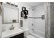 Updated bathroom featuring a bathtub with shower, subway tile, floating shelves and a modern vanity at 343 37Th Ne Ave, St Petersburg, FL 33704