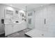 Modern bathroom with double sink vanity, glass shower, and decorative textured wall tiles at 343 37Th Ne Ave, St Petersburg, FL 33704