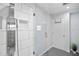 Modern bathroom features a glass enclosed shower, white tiled walls, and a stainless steel shower panel at 343 37Th Ne Ave, St Petersburg, FL 33704