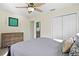 Comfortable bedroom featuring wooden dresser, plush bed, ceiling fan, and ample closet space at 343 37Th Ne Ave, St Petersburg, FL 33704