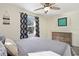 Serene bedroom featuring a wooden dresser, ceiling fan, and sun-drenched window at 343 37Th Ne Ave, St Petersburg, FL 33704