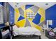 bedroom featuring a bed, bookcase, and colorful wall decor with planets and geometric patterns at 343 37Th Ne Ave, St Petersburg, FL 33704