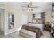 Relaxing bedroom with wood furnishings, ceiling fan, and plush upholstered bench at 343 37Th Ne Ave, St Petersburg, FL 33704