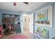 Bright bedroom boasts open closet with organized clothes, bookcase, rug, and decor for playful, functional space at 343 37Th Ne Ave, St Petersburg, FL 33704