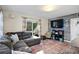 Comfortable living room features a large sectional sofa, textured wall, and sliding glass doors to the yard at 343 37Th Ne Ave, St Petersburg, FL 33704