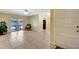 Bright living room with tile floors, ceiling fan, and sliding glass doors leading to the pool area at 3543 Stokes Dr, Sarasota, FL 34232