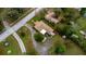 Aerial view of home showcasing mature landscaping, large lot, and paved driveway at 37713 Florida Ave, Dade City, FL 33525