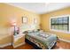 Bedroom featuring a quaint bed with side tables, lamps, and a window at 37713 Florida Ave, Dade City, FL 33525