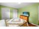 Bedroom featuring a dresser with a TV and a cozy quilt at 37713 Florida Ave, Dade City, FL 33525