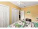 Cozy bedroom with a quilt, white trim, and paneled walls at 37713 Florida Ave, Dade City, FL 33525