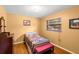 Bright bedroom with wood floors, window with blinds, and quaint decor at 37713 Florida Ave, Dade City, FL 33525