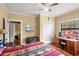 Bright bedroom with a wooden desk, trunk, and a colorful quilt on the bed at 37713 Florida Ave, Dade City, FL 33525