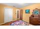 Cozy bedroom with wood floors, natural light, and a decorative quilt-covered bed at 37713 Florida Ave, Dade City, FL 33525