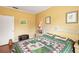 Bedroom featuring paneled walls, hardwood floors, and a quilt-covered bed at 37713 Florida Ave, Dade City, FL 33525
