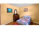 Bedroom featuring a dresser, wooden floors, and colorful quilt at 37713 Florida Ave, Dade City, FL 33525