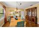 Formal dining room with wooden floors, chandelier, and built-in wooden cabinet at 37713 Florida Ave, Dade City, FL 33525