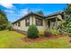 Attractive home exterior with manicured shrubs, mulched flowerbeds, and covered front porch at 37713 Florida Ave, Dade City, FL 33525