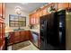 Inviting kitchen features wood cabinets, black appliances and tile backsplash at 37713 Florida Ave, Dade City, FL 33525