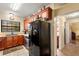 Well-equipped kitchen featuring wood cabinetry, granite counters, and modern black refrigerator at 37713 Florida Ave, Dade City, FL 33525