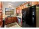 Traditional kitchen with dark wood cabinets, granite countertops, and stainless steel dishwasher at 37713 Florida Ave, Dade City, FL 33525