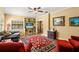 Bright living room with hardwood floors, bookshelves, and comfortable furniture at 37713 Florida Ave, Dade City, FL 33525